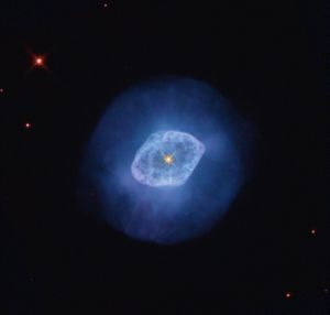Bright blue nebula with a darker blue halo and a bright orange-yellow star at its center.